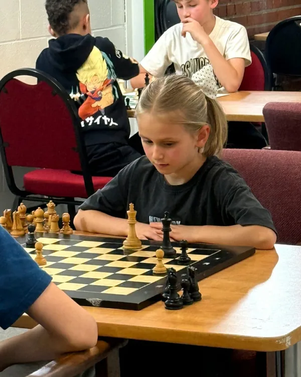 Alexandra, a young chess student at WhiteKnight Academy