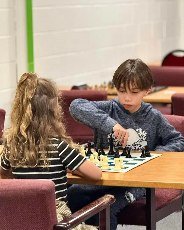 Evan, a young chess student at WhiteKnight Academy